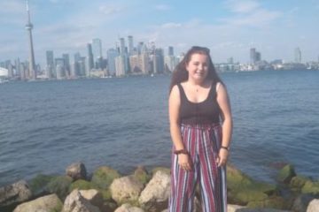 Maiya standing on the shore of Lake Ontario, Toronto