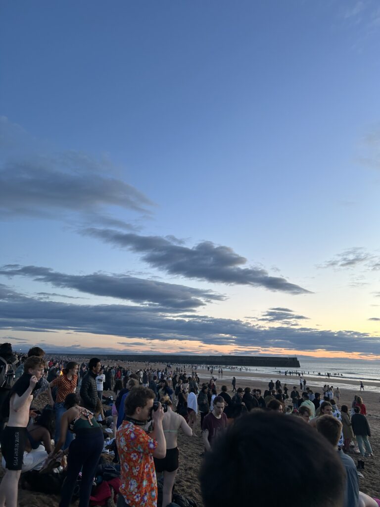 Many people gathering on the beach.