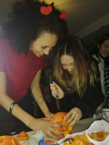 Two people carving a pumpkin