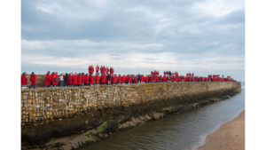 Students in red gowns for annual pier walk