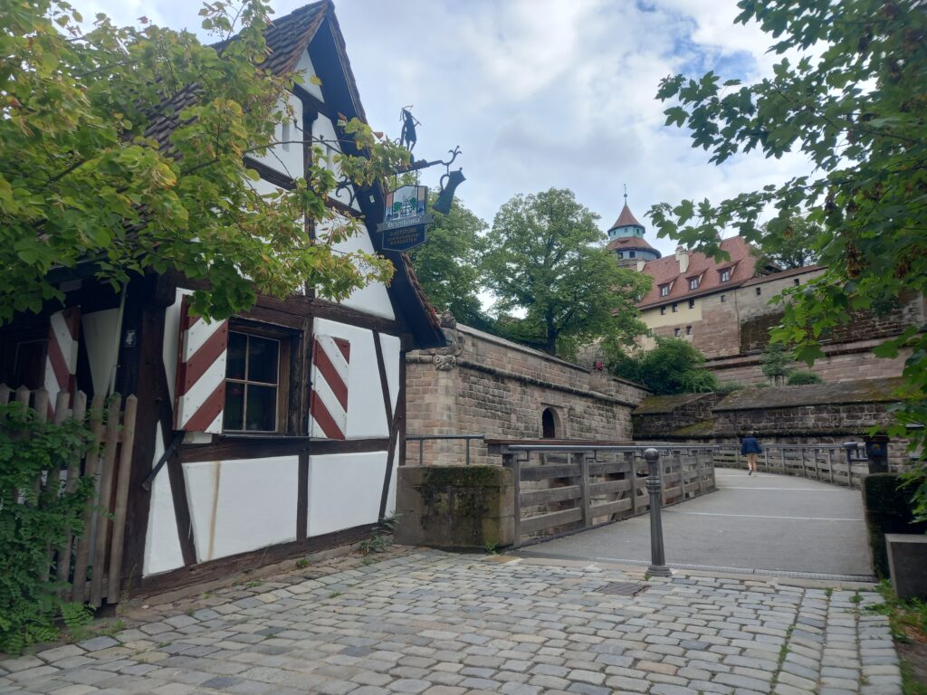 A half timbered pub and stone castle in Nuremberg Germany.
