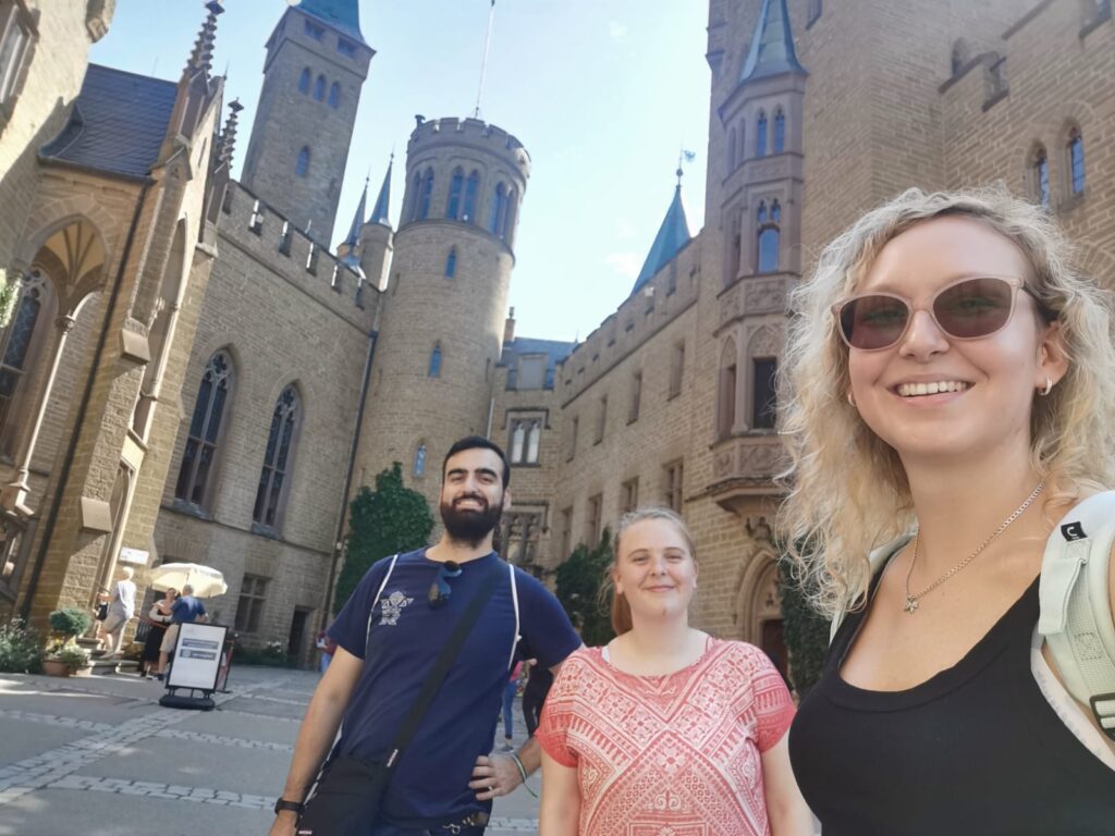 Group of students visting Hohenzollern castle, with yellow grey stonework