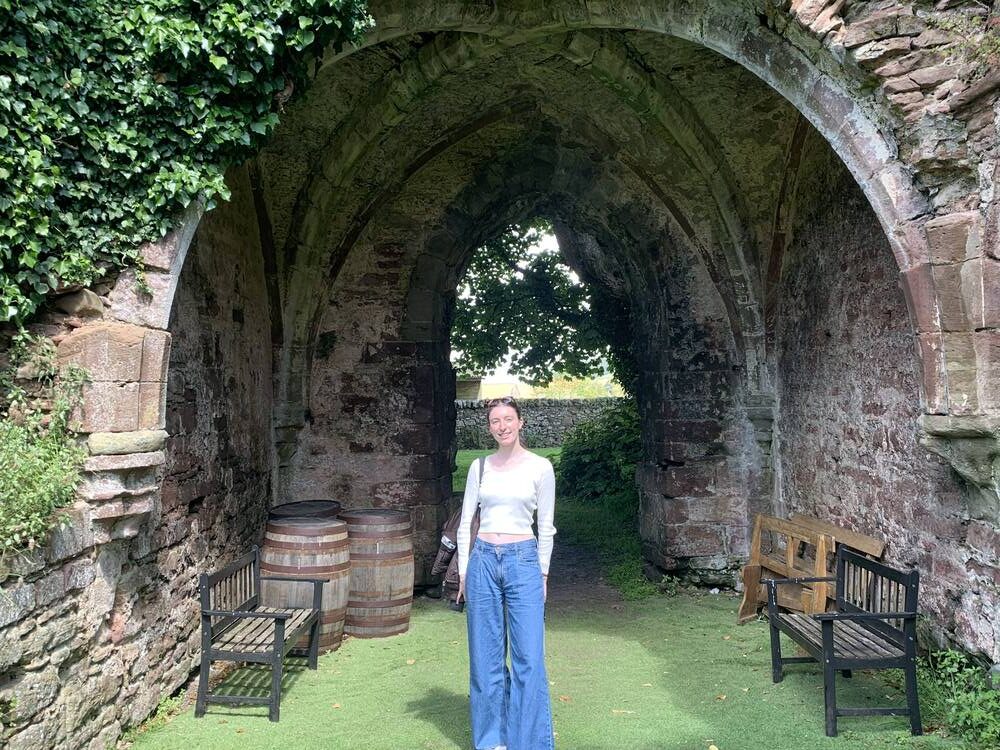 Kate standing under arch at Lindores Abbey