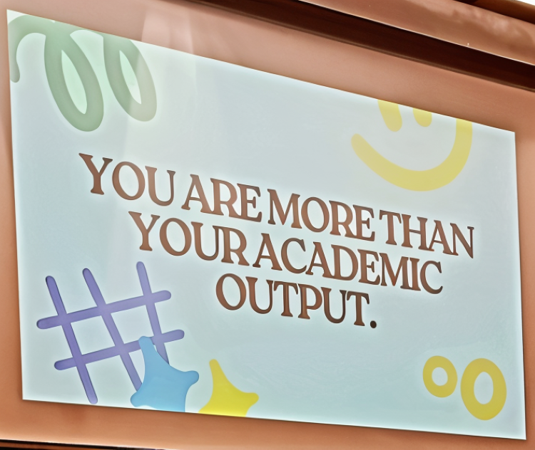 A presentation slide reads "you are more than your academic output"