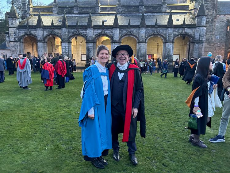 Student and academic in Quad during graduation