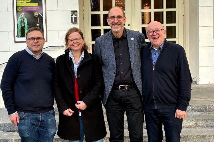 Four Bonn and St Andrews researchers outside a building